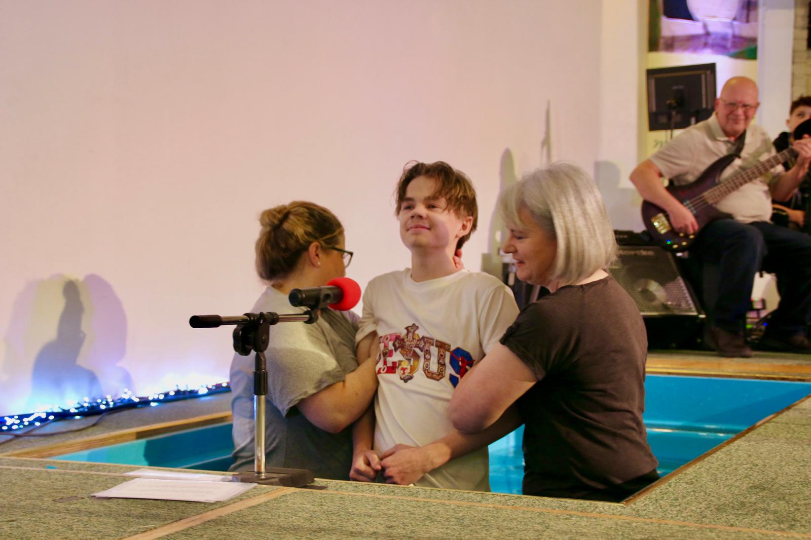 A baptism at Milton Baptist Church, with church leaders supporting the person in the pool