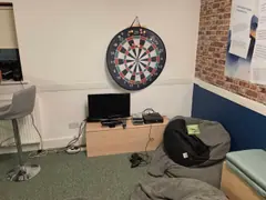 The Youth Room's games console area and dartboard