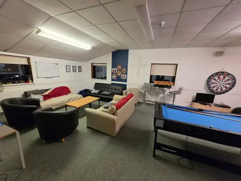 Sofas and a pool table in the Upstairs Youth Room