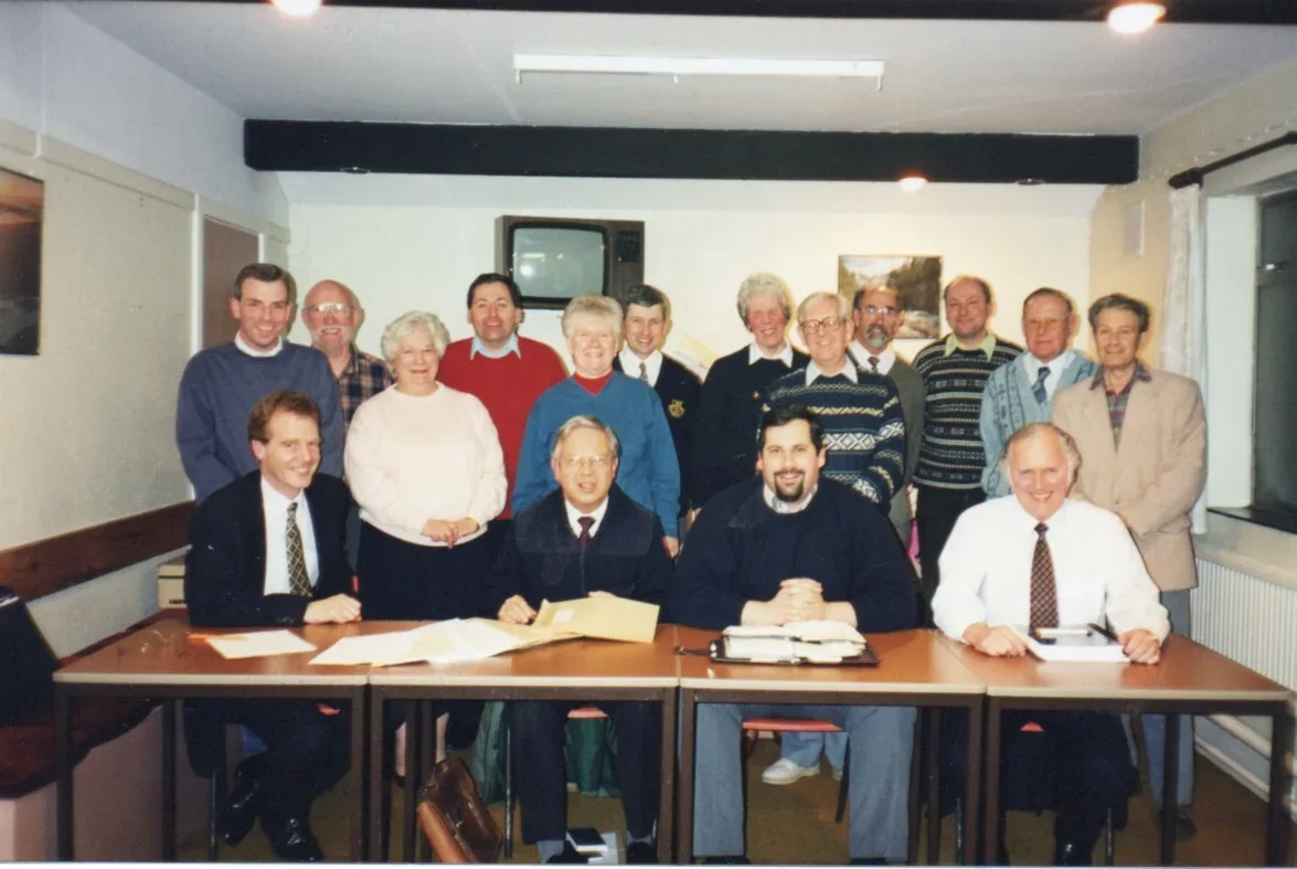 Church deacons and the architect seated together to sign the building contract