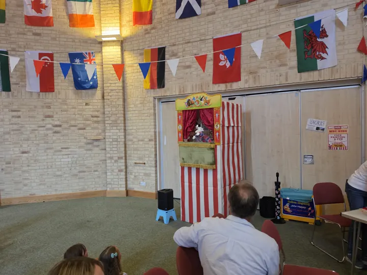 Children and adults watching the Punch and Judy show at the Vintage Fayre.