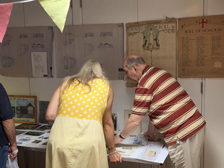 Visitors exploring displays about Milton Baptist Church's history.