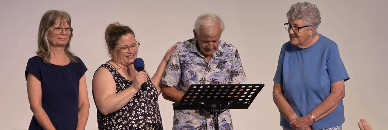 Four members of MBC sharing a joyful moment during a baptism service