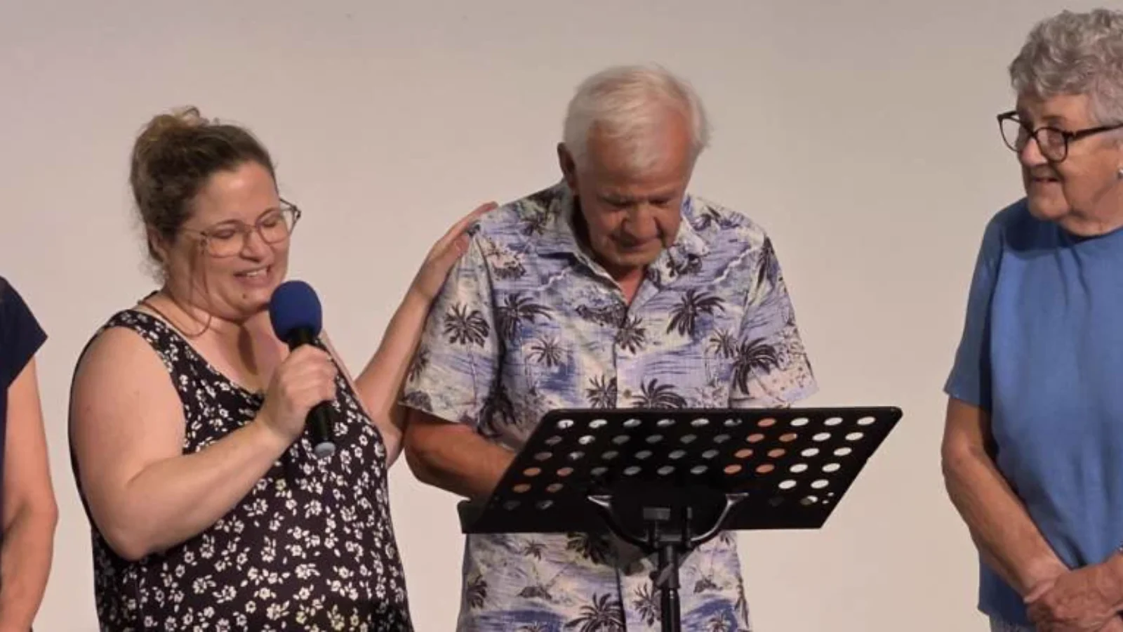 Four members of MBC sharing a joyful moment during a baptism service